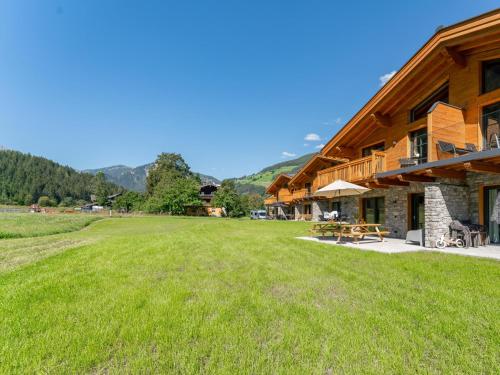 a large grass field in front of a building at FIIF Pinzgau in Wald im Pinzgau