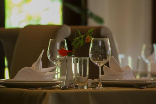 a table with wine glasses and napkins on it at Harmony Valley Retreat in Bukit Tinggi