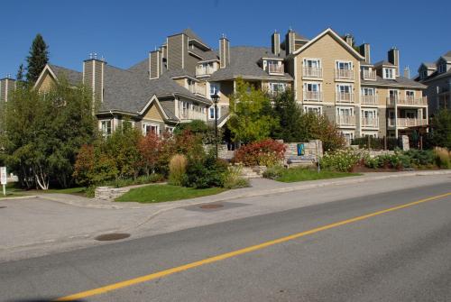 a large house on the side of a street at Ermitage du Lac in Mont-Tremblant