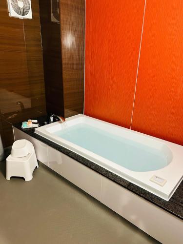 a bathroom with a bath tub and a toilet at Pal Annex Nakatsu (Love Hotel) in Nakatsu