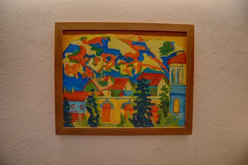 a painting of a house on a wall at Chesa Munteratsch 1 1 2-Zimmerwohnung 209 Typ D in Silvaplana