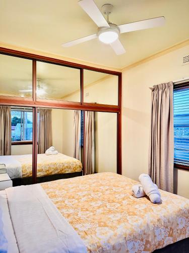 a bedroom with two beds and a ceiling fan at Rose Homey Home in Glenorchy
