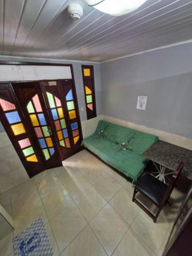 a room with a bed and stained glass windows at Kitnets com AR Condicionado na Praia in Salvador