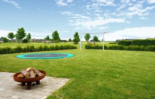 a bench in the middle of a park with a basketball hoop at Gorgeous Home In Haderslev With Wifi in Haderslev