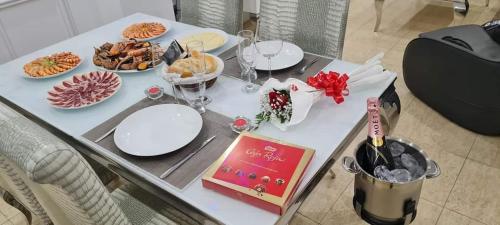 a white table with plates of food on it at Oceanum Visum Spa Deluxe in El Trocadero