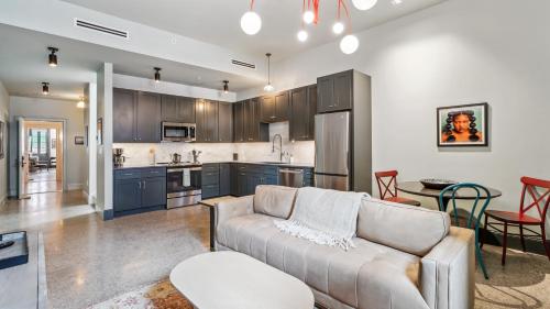 a living room with a couch and a kitchen at The Mary Beth Hotel & Gallery in New Orleans