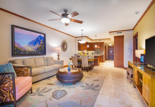 a living room with a couch and a table at Koloa Landing Resort at Po'ipu, Autograph Collection in Koloa