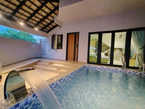 a bathroom with a bath tub with a shower and a tub at D Laman Santai 17Pax 5R4B Near TC Beach in Kuantan