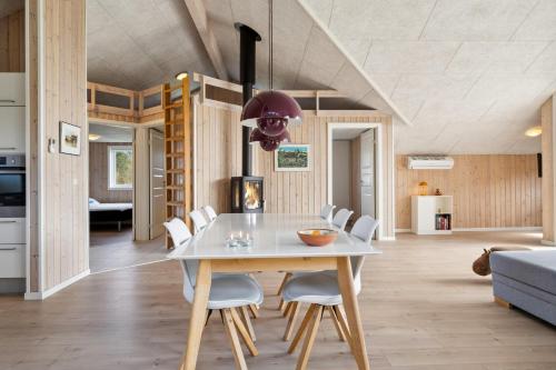 a dining room with a white table and white chairs at Modern Holiday Home From 2017, Located At Lild Strand in Frøstrup