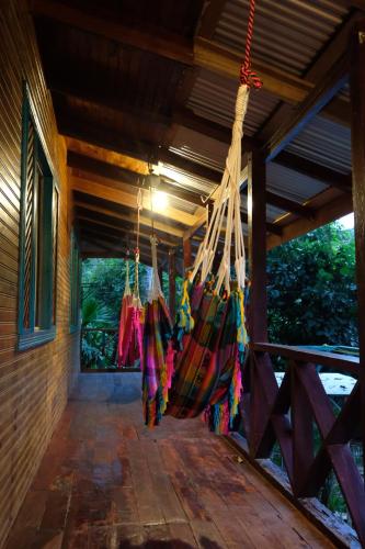 a porch of a house with hammocks hanging from it at Casa Aldirica in Cahuita