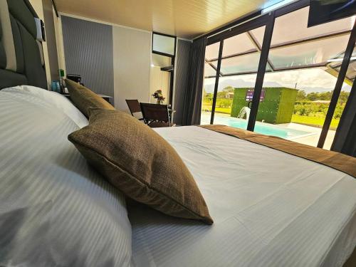 a bedroom with a large bed with pillows on it at Casa Cristal # 1 in Fortuna