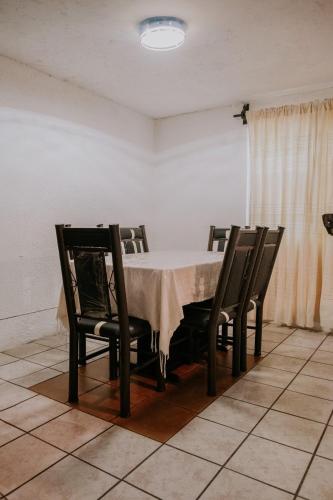 a dining room with a table and four chairs at Departamento en Bahías de Huatulco in Santa Cruz Huatulco