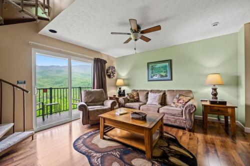 a living room with a couch and a table at Above The Clouds in Gatlinburg