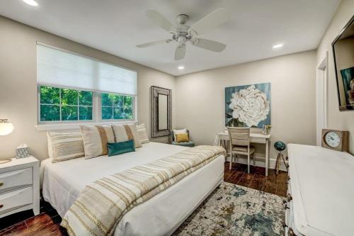 a bedroom with a bed and a window and a desk at Elegant Mansion on Park in Historic Avondale in Jacksonville