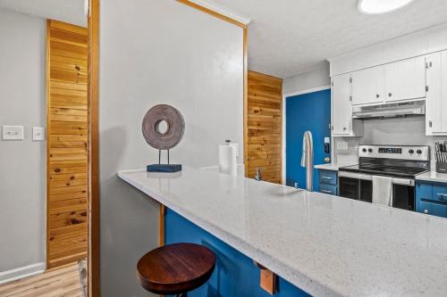 a kitchen with blue and white cabinets and a counter at Misty Mountain Getaway in Gatlinburg