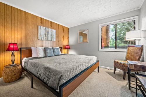 a bedroom with a bed and a table and a window at Misty Mountain Getaway in Gatlinburg