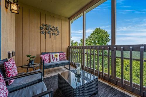 a screened in porch with a couch and a table at Misty Mountain Getaway in Gatlinburg
