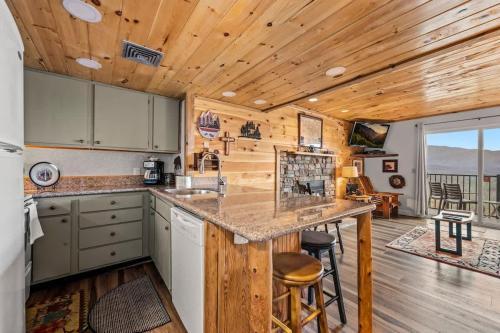 a kitchen with a large island in a cabin at Whispering Woods Condo in Gatlinburg