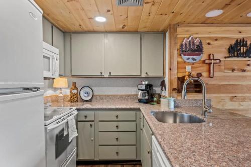 a kitchen with a sink and a counter top at Whispering Woods Condo in Gatlinburg