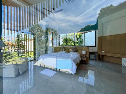 a large bedroom with a bed and large windows at Celine House by Craft Village in Chaweng