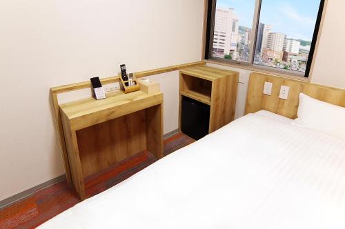 Postel nebo postele na pokoji v ubytování Sasebo Green Hotel