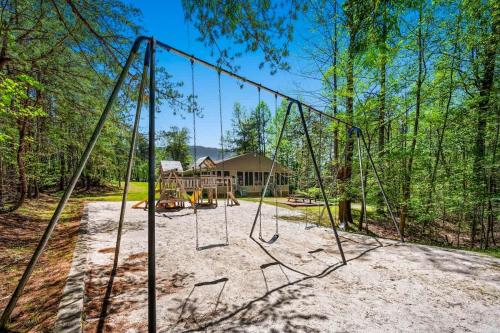 an empty swing set in front of a house at Rocky Top Oasis in Gatlinburg