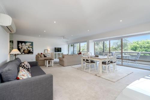 a living room with a couch and a table at Spacious 2-Bed Apartment Near Dining & Attractions in Kingston