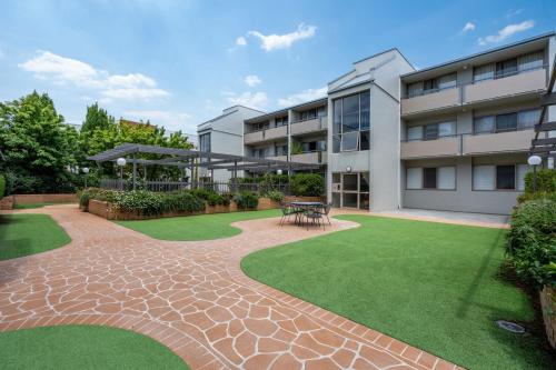 an apartment building with a lawn in front of it at Spacious 2-Bed Apartment Near Dining & Attractions in Kingston