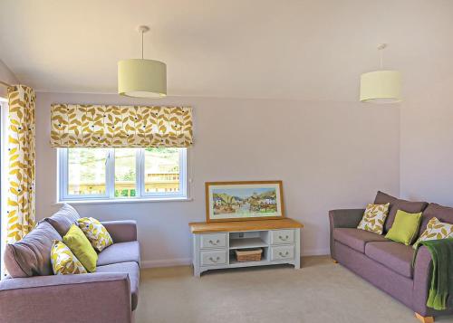 a living room with two purple couches and a window at Kingswood Golf Lodges in Thorne