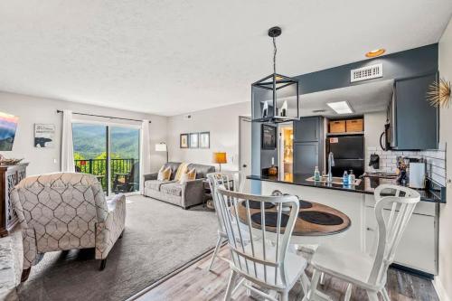 a kitchen and living room with a table and chairs at Point of View in Gatlinburg
