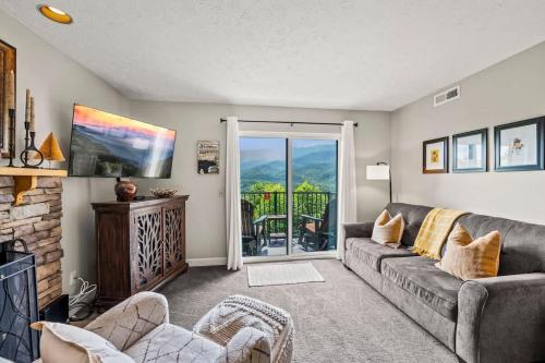 a living room with a couch and a balcony at Point of View in Gatlinburg