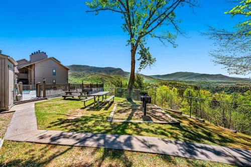 a patio with a picnic table and a tree at Point of View in Gatlinburg