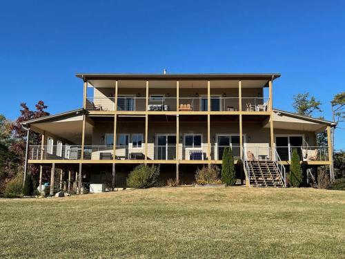 a large house with balconies and a yard at Heaven's Summit in Gatlinburg