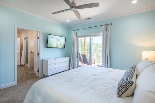 a blue bedroom with a bed and a ceiling fan at Heaven's Summit in Gatlinburg