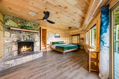 a bedroom with a fireplace in a log cabin at Sunrise View Chalet in Gatlinburg