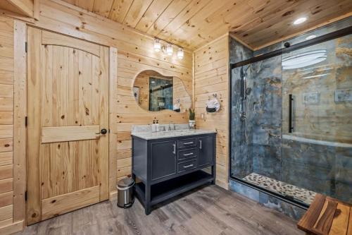 a bathroom with a black sink and a shower at Sunrise View Chalet in Gatlinburg