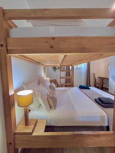 a bedroom with a large bed with a wooden frame at La Villa Harmonie in Sainte-Luce