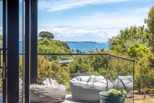 a balcony with a view of the water at Empire Views, Oneroa - Be My Guest Waiheke in Oneroa