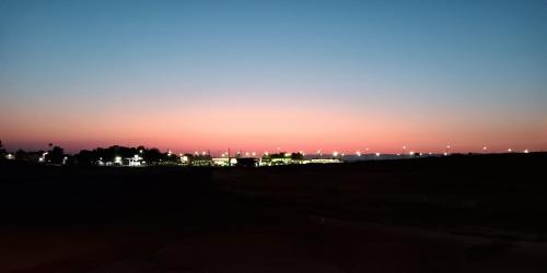 a sunset with a city in the background at Amber Inn Motel in Bliss