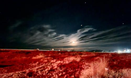 a view of a field at night with a moon at Amber Inn Motel in Bliss
