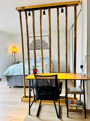 a table and a chair in a room with a bed at Comfy loft in La Candelaria in Bogotá