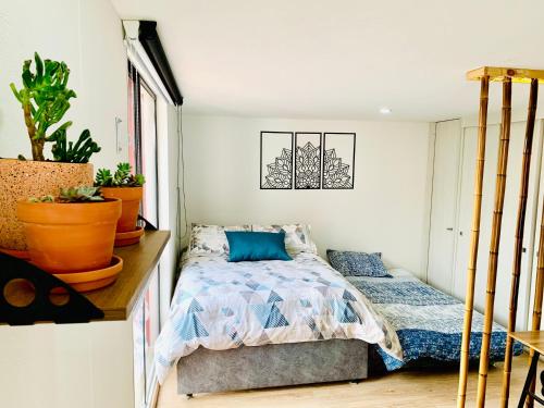 a small bedroom with a bed and a window at Comfy loft in La Candelaria in Bogotá