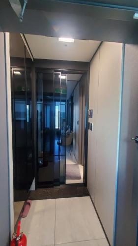 an office hallway with a door leading into a room at 1 minute to the beach! Free parking! Sauna and gym in Busan