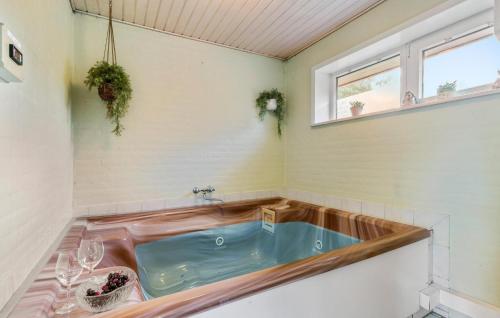 a bathroom with a hot tub in a sink at Nice Home In Nørre Nebel With Sauna in Nørre Nebel
