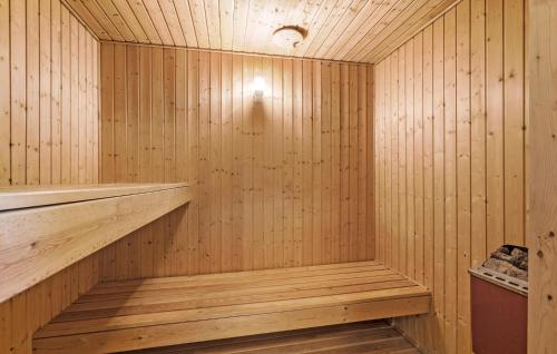 a sauna with wooden walls and a wooden floor at Nice Home In Nørre Nebel With Sauna in Nørre Nebel