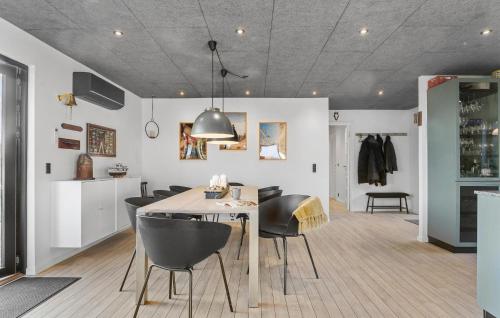 a kitchen and dining room with a table and chairs at Stunning Home In Endelave With Wifi in Sønderby