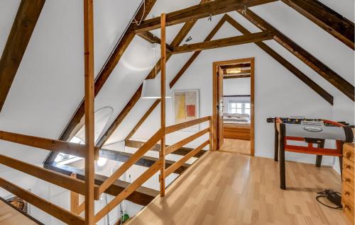 a staircase in a room with wooden beams at Gorgeous Home In Ulfborg With Sauna in Ulfborg