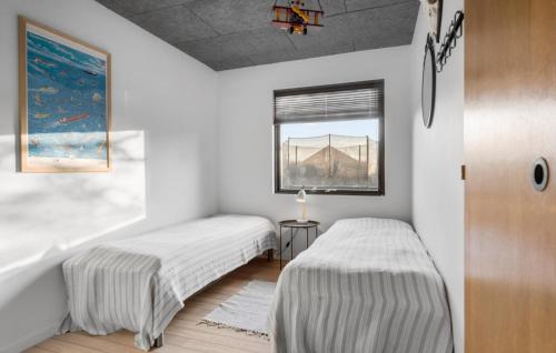 two beds in a room with a bridge at Stunning Home In Endelave With Wifi in Sønderby