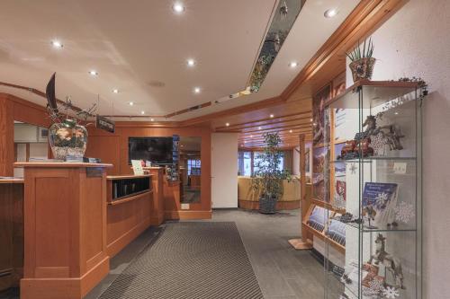 a large room with wooden walls and a display case at Hotel Alpin Superior in Saas-Fee