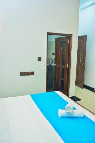 a room with a bed with a blue floor at Ocean Bliss Villa Mirissa in Kamburugamuwa